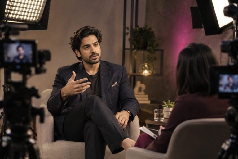 Actor gestures while answering questions in a studio interview